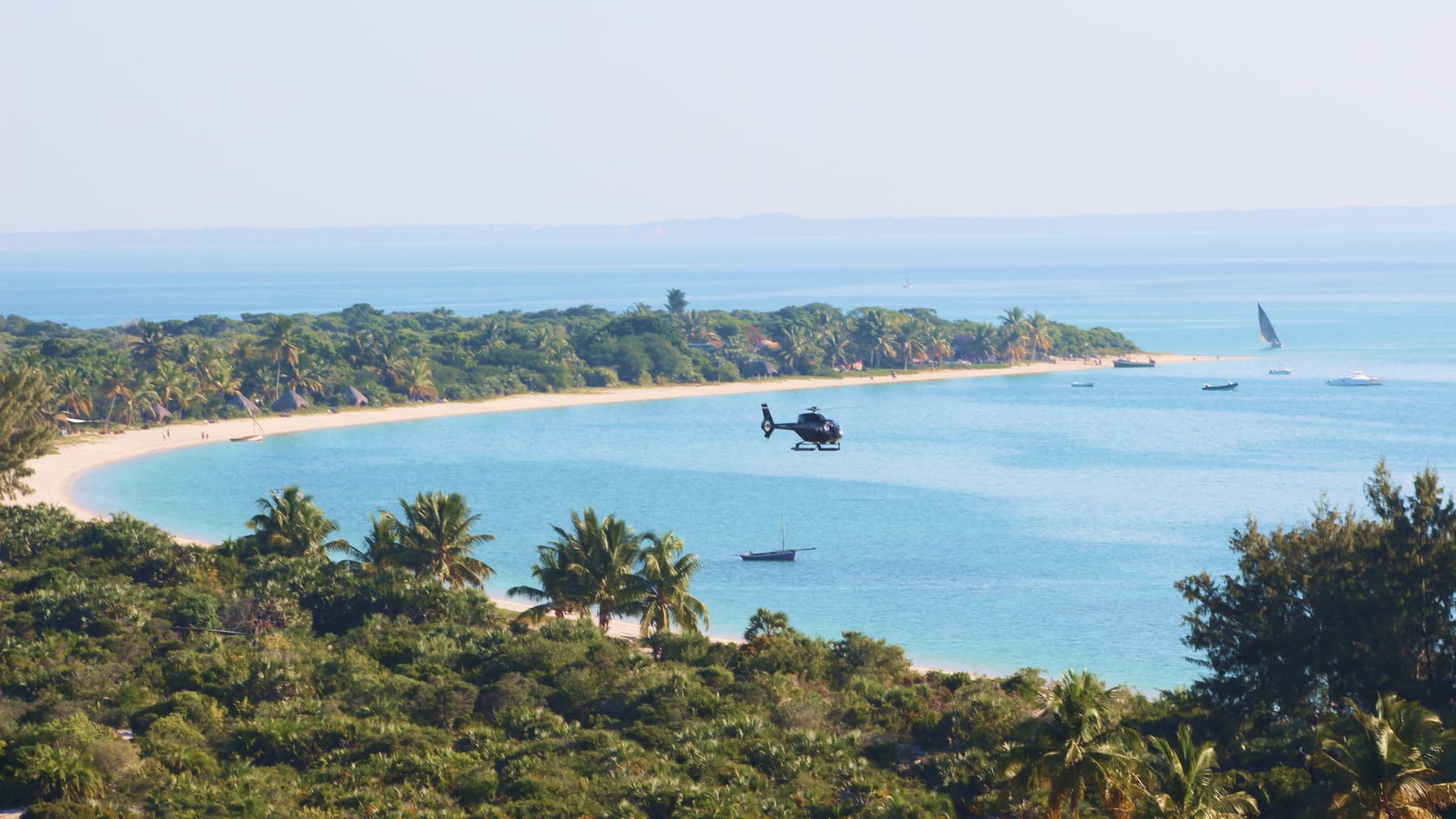 Helicopter flying over a Bazaruto island in turquoise waters